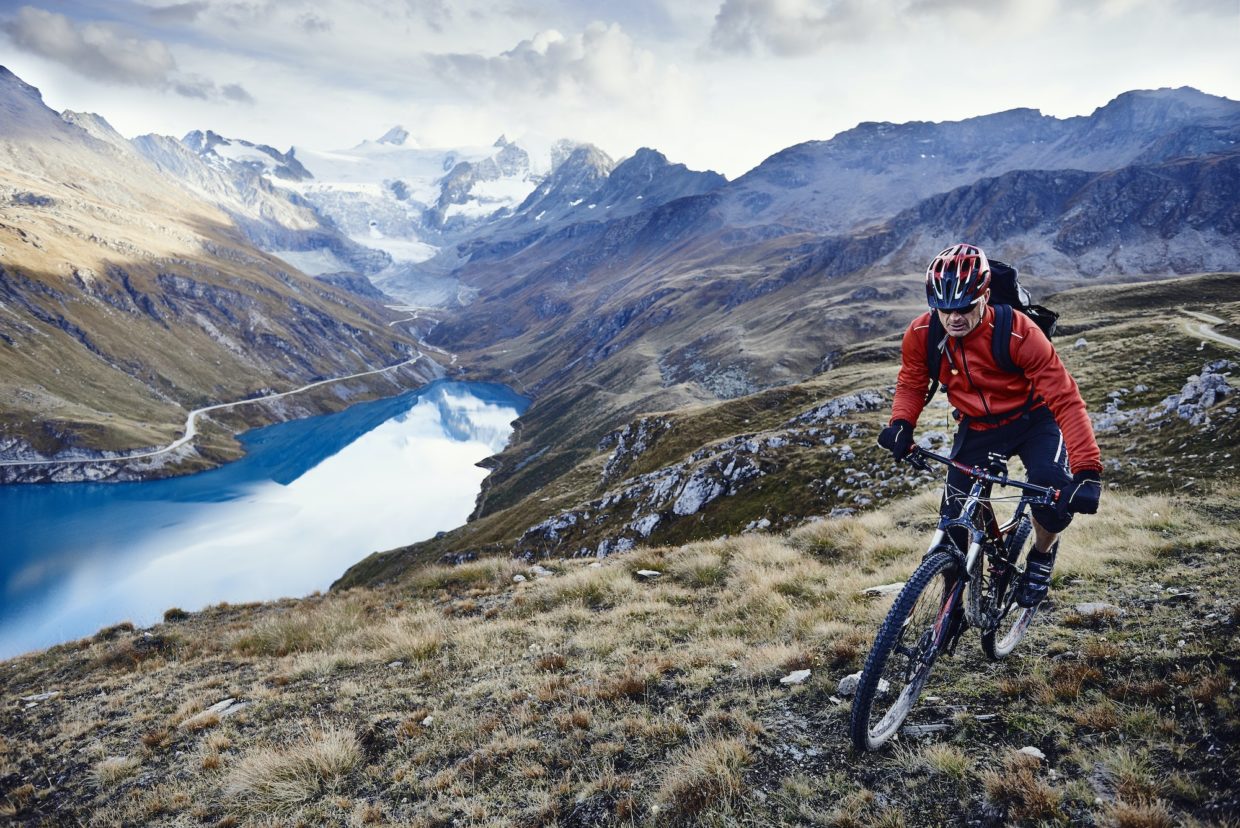a man riding a bike on a mountain