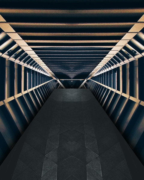 a long black hallway with a black carpet