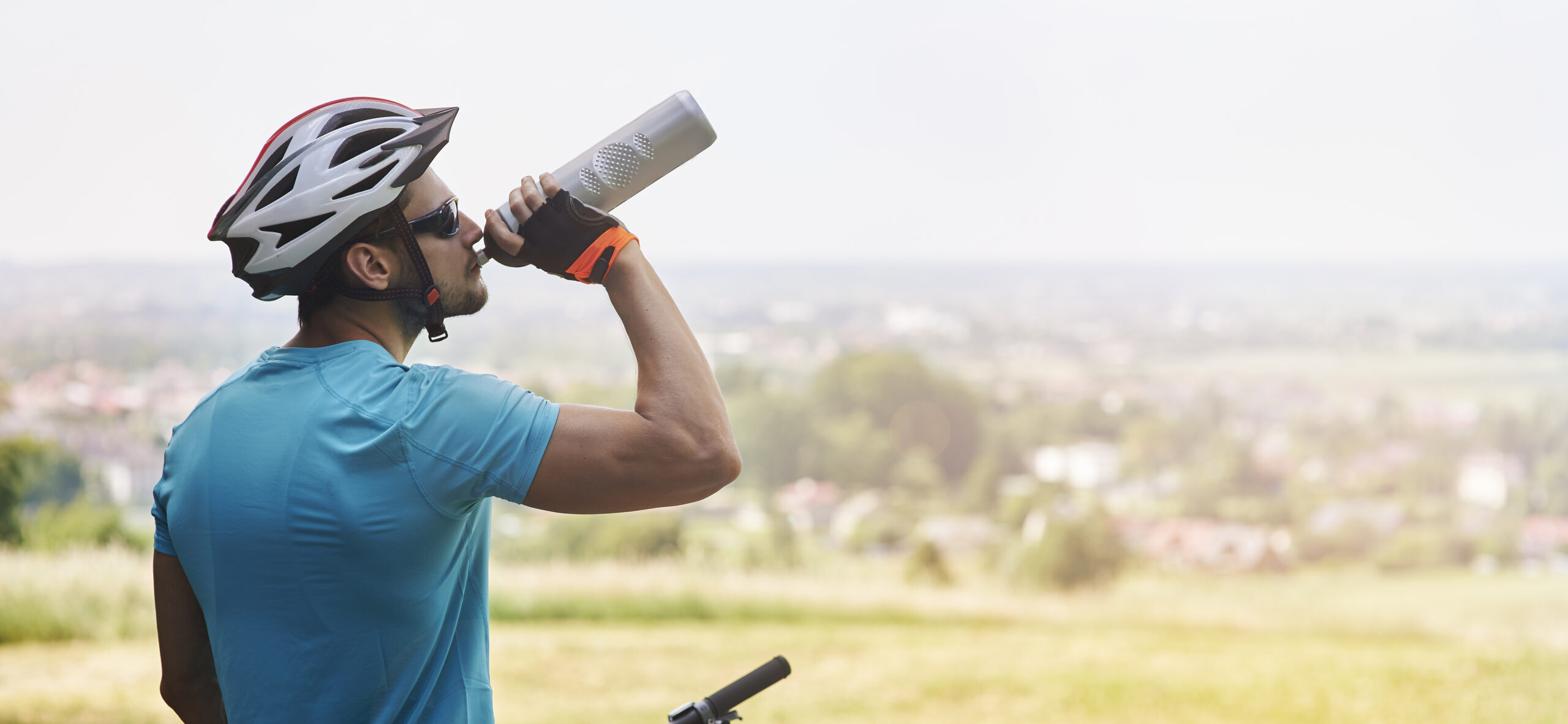 a man drinking from a bottle